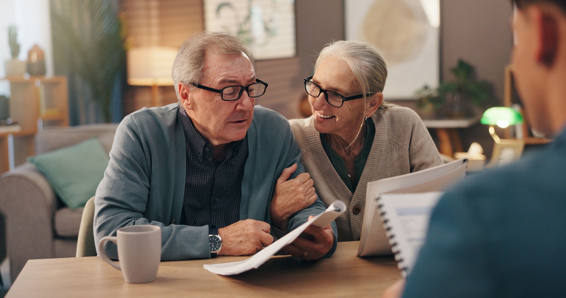 Senior couple, documents and financial advisor with retirement plan for asset management at house. Elderly man, woman and paperwork with accountant for pension fund or application at old age home